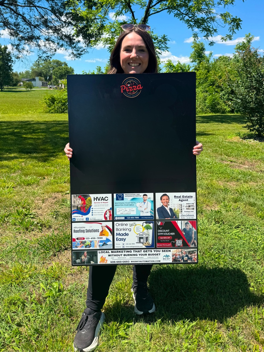 A finished 24 by 36 inch community board with local business ads along the bottom